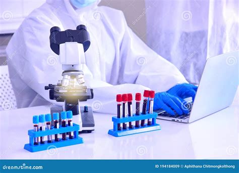 Blood Testing Laboratory Samples Viewing Under Microscope Near Tubes