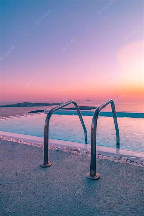 Premium Photo | Infinity pool on the rooftop at sunset in santorini ...