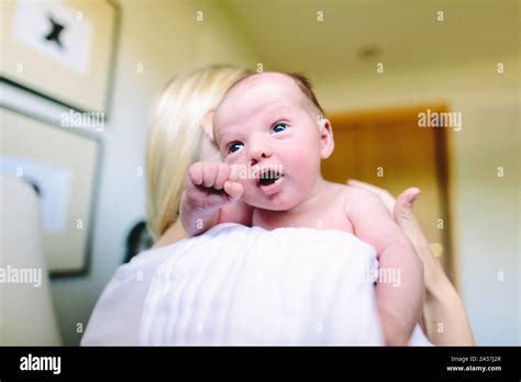 Over The Shoulder View Of A Newborn Baby Boy In His Mother S Arms Stock