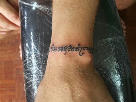 A Person With A Tattoo On Their Wrist