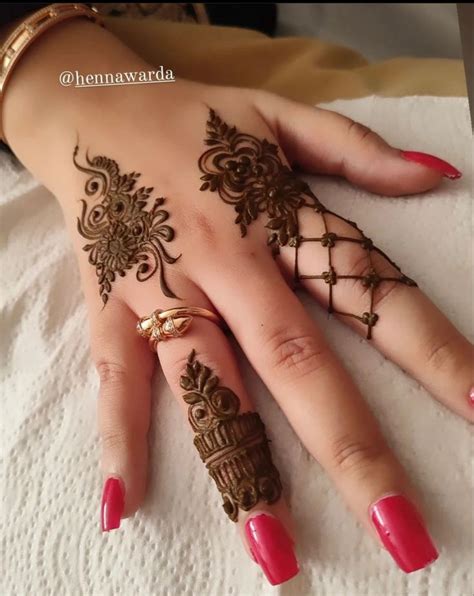 A Woman S Hand With Henna Tattoos On It