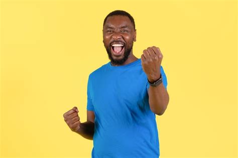 Premium Photo Emotional African American Guy Shaking Fists Standing