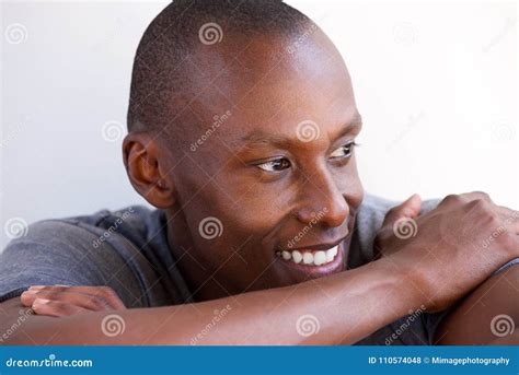 Close Up Handsome African American Man Smiling And Looking Away Against