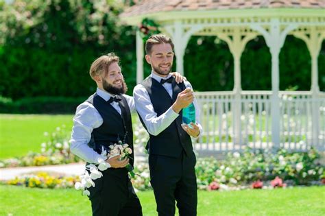 Premium Photo Excited Gay Couple Open Champagne On Wedding Day