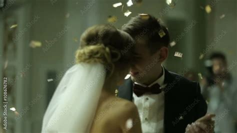 Beautiful Brunette Bride And Handsome Groom Dancing First Dance At The Wedding Party Confetti