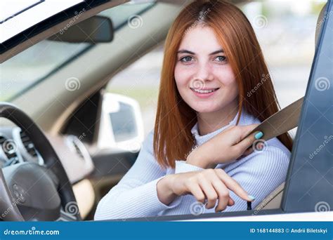 Wide Angle View Of Young Redhead Woman Driver Fastened By Seatbelt