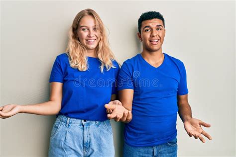 Young Interracial Couple Wearing Casual Clothes Smiling Cheerful With