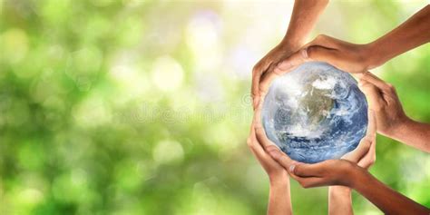 Conceptual Symbol Of Multiracial Human Hands Surrounding The Earth