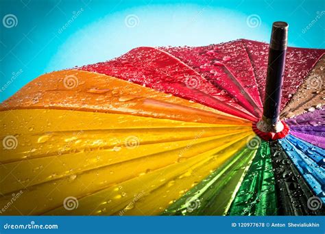 Raindrops On A Colorful Umbrella With All The Colors Of The Rainbow