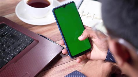 Young Man Hand Holding Smart Phone With Green Screen 22649213 Stock