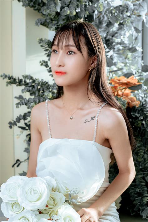 Woman Holding A White Wedding Bouquet · Free Stock Photo