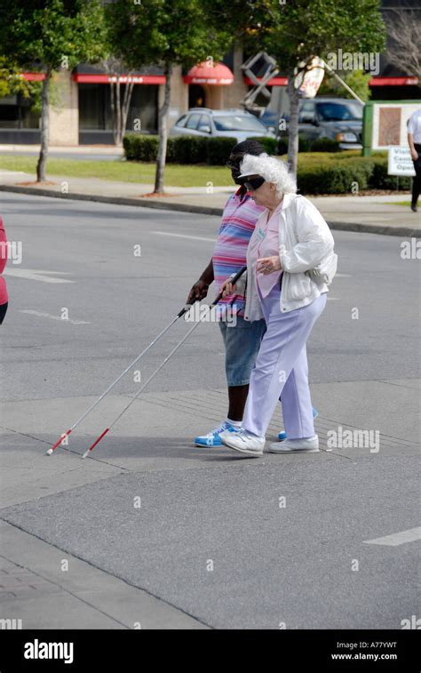 Group Of Blind People Cross The Street Using Canes Stock Photo Alamy