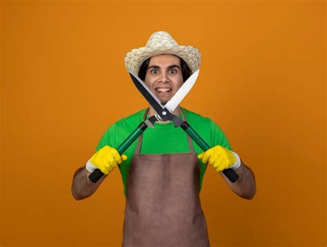 Jovem Jardineiro Sorridente De Uniforme Usando Chap U De Jardinagem E