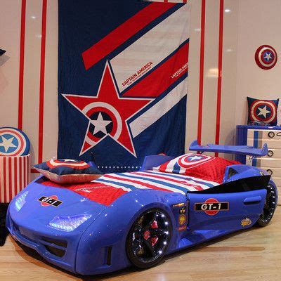 a blue car bed with captain america decorations on the wall