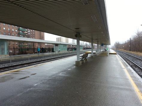 A Train Station With Benches On The Platform