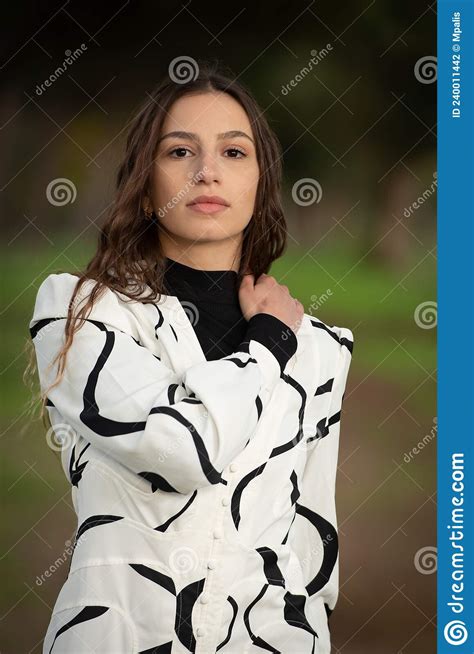 Headshot Portrait Of A Young Woman With Long Hair Wearing Black And