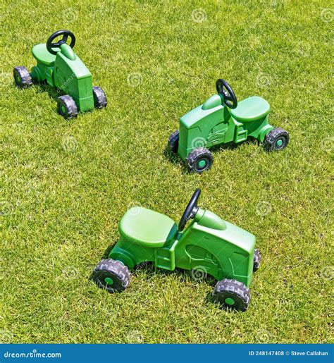 Three Children`s Toy Farm Tractors in Spring Grass Stock Photo - Image ...