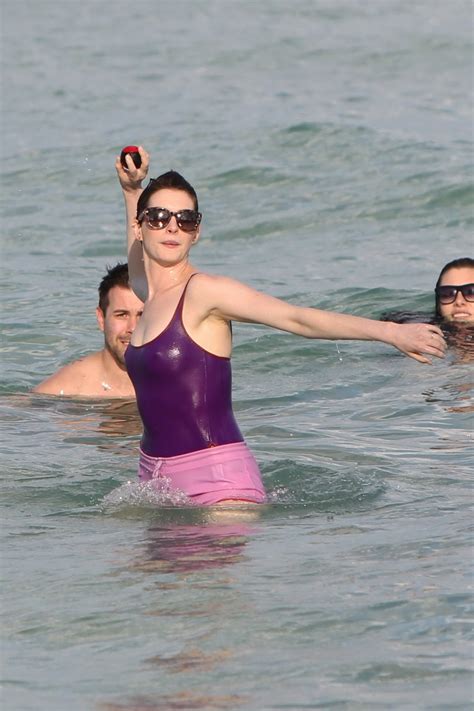 Anne Hathaway Wearing Wet Purple See Through Swimsuit And Shorts At The Beach In Porn Pictures