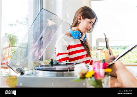 Young Woman At Home Looking At Records Stock Photo Alamy