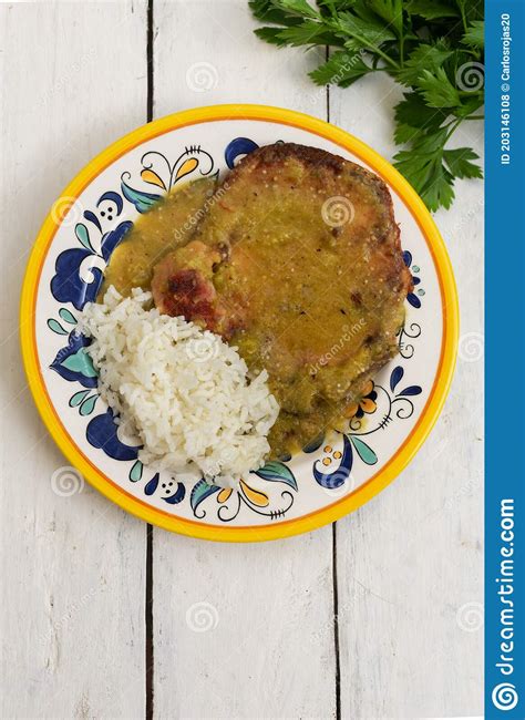 Mexican Smoked Pork Chops With Green Sauce And Rice On White Background