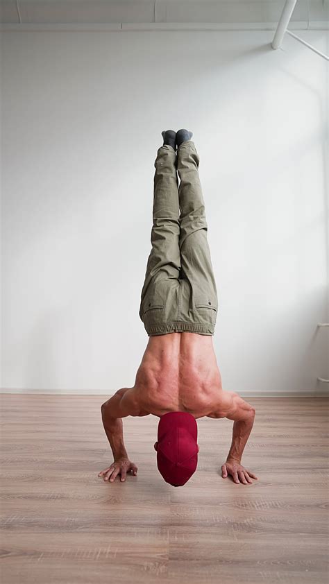 Athletic Muscular Man Naked To The Waist Doing Push Ups In A Handstand