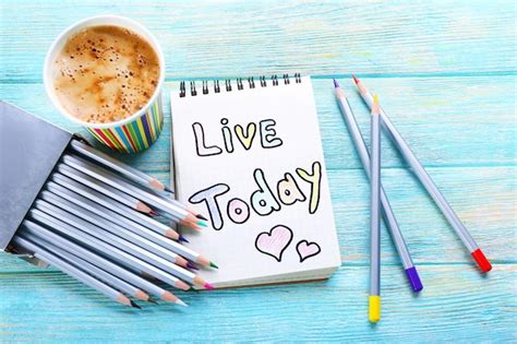 Premium Photo Cup Of Coffee With Note Live Today And Crayons On