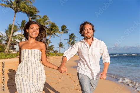 Happy Newlyweds Couple Running On The Beach Holding Hands Honeymoon