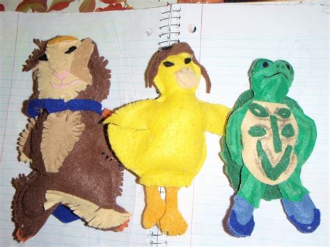 three stuffed animals are sitting next to each other on a notebook with ...