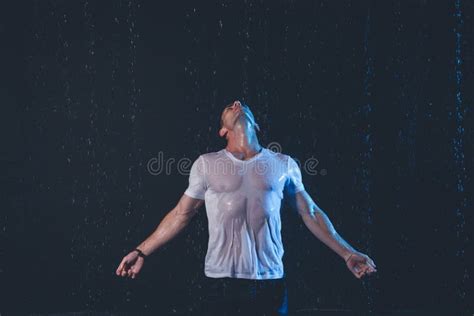 Fresh Portrait Of Muscular Man With Water Splashes On Dark Background