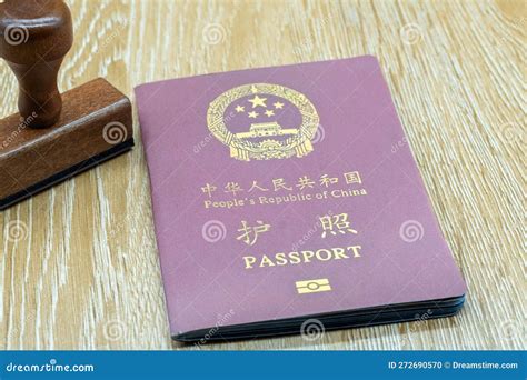 A Chinese Passport On A Wooden Table Symbolize An Upcoming Trip And The Republic S Identity