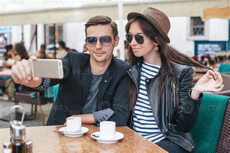 Two People Drinking Coffee In Outdoor Cafe Enjoying The Time Spending