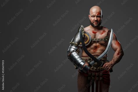 Portrait Of Powerful Gladiator From Past With Naked Torso And Muscular Build Stock Photo