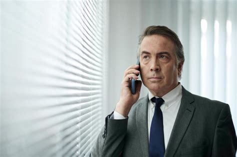 Premium Photo Portrait Of Unhappy Mature Businessman Talking On Phone