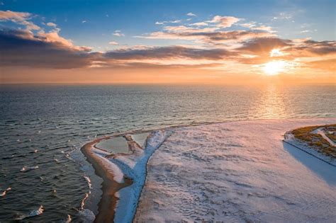 Premium Photo | Snowy beach on Hel peninsula at sunrise winter Baltic Sea