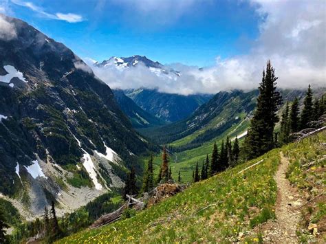 There Is A Trail Going Up The Side Of A Mountain With Mountains In The