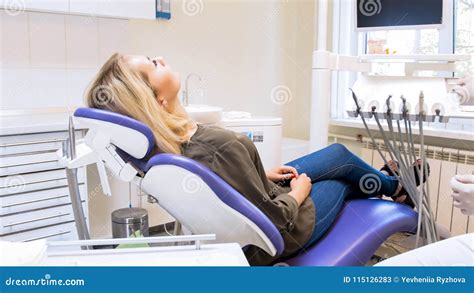 Beautiful Young Woman Lying In Dentist Chair And Waiting For Doctor