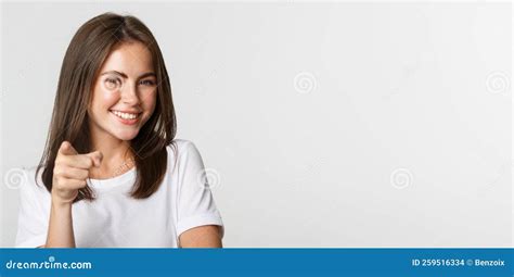 Close Up Of Happy Smiling Brunette Girl Pointing At Camera Standing