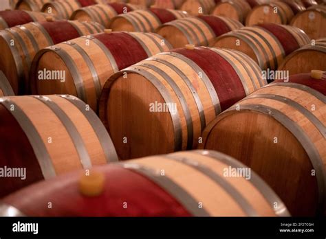 Wine Barrels Stacked In The Old Cellar Of The Winery Selective Focus