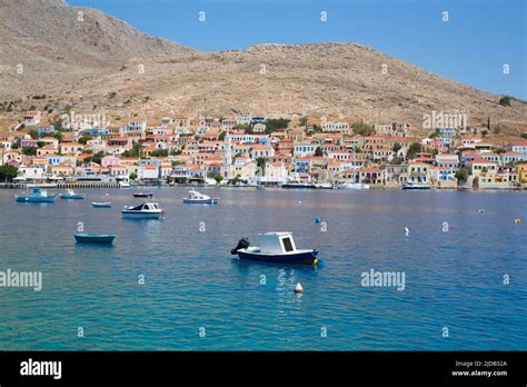 Fishing Boats Anchored Off Shore In The Harbor At Emborio The Main