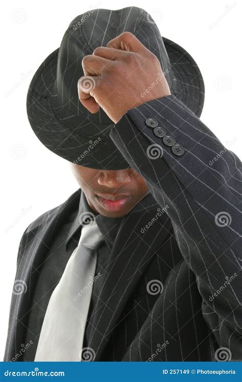 Attractive Young Man In Pinstripe Suit Tipping His Hat Royalty Free