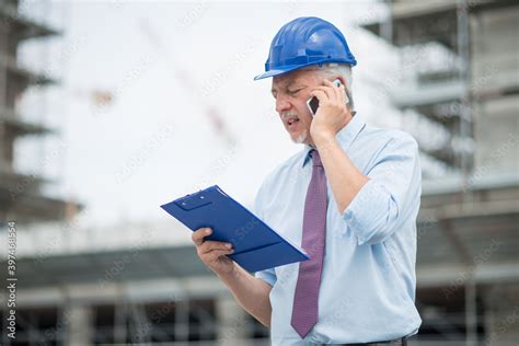 Architect at work in front of construction site Stock Photo | Adobe Stock