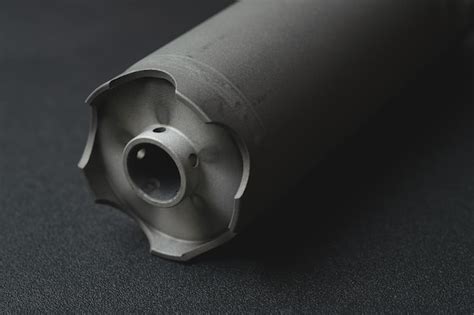 Premium Photo | Part from a firearm professional silencer from a rifle ...