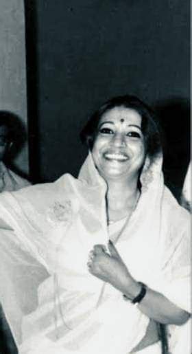 An Old Photo Of A Smiling Woman Wrapped In A Blanket