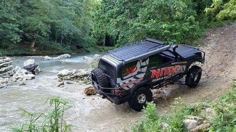 An Off Road Vehicle Is Driving Through The Water