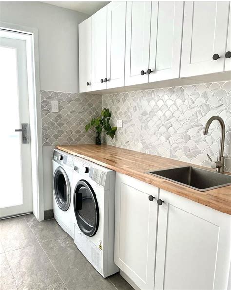 a washer and dryer sitting in a kitchen next to each other with white ...