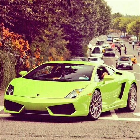 A Green Sports Car Is Parked On The Side Of The Road