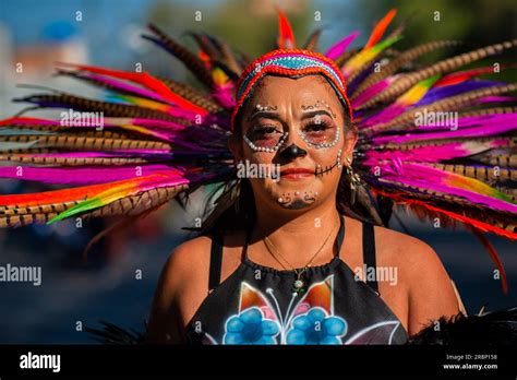 A Young Mexican Woman Wearing An Aztec Feather Headdress Takes Part