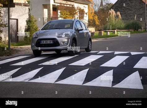 Car going over Speed bump / Sleeping policeman, France Stock Photo - Alamy