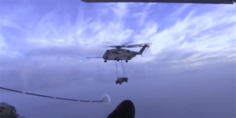 Sea Stallion Refuels From Kc J Carrying A Humvee Over The Ocean