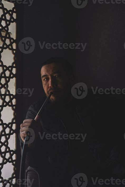 A Guy Smokes Hookah In Shisha Bar 34703623 Stock Photo At Vecteezy